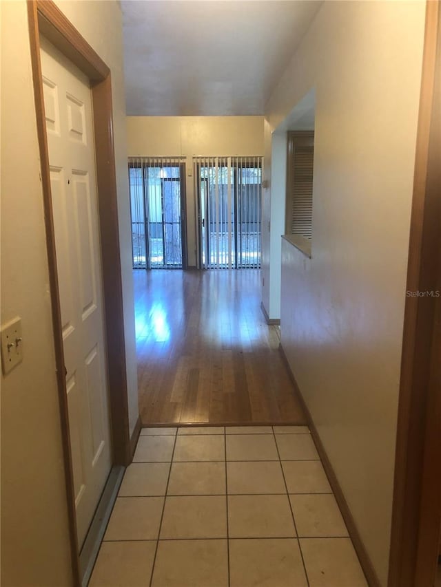 corridor featuring light tile patterned floors