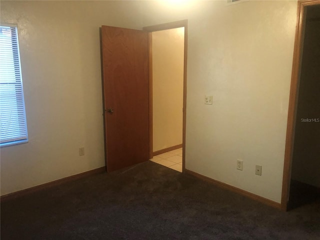 unfurnished room featuring light colored carpet