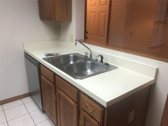 kitchen with dishwasher, sink, and light tile patterned flooring