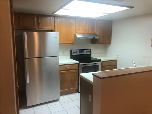 kitchen featuring light tile patterned floors and appliances with stainless steel finishes