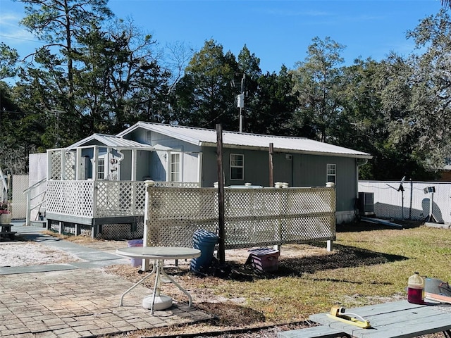 rear view of property featuring central AC