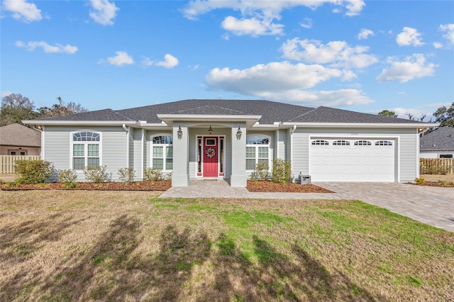 single story home with a garage and a front yard