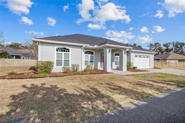 single story home with a garage and a front lawn