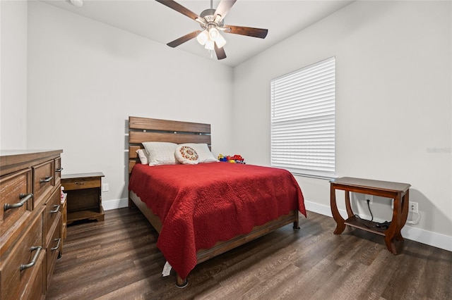 bedroom with dark hardwood / wood-style flooring and ceiling fan