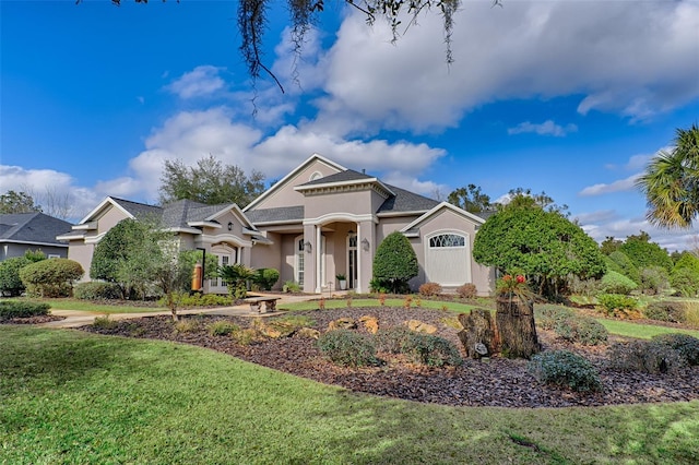 view of front of property featuring a garage and a front lawn