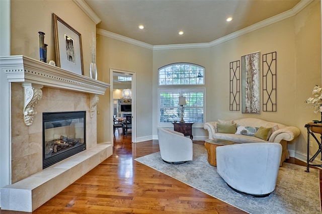 living room featuring light hardwood / wood-style flooring, a fireplace, and ornamental molding