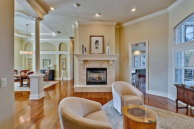 interior space featuring decorative columns, ornamental molding, and hardwood / wood-style floors