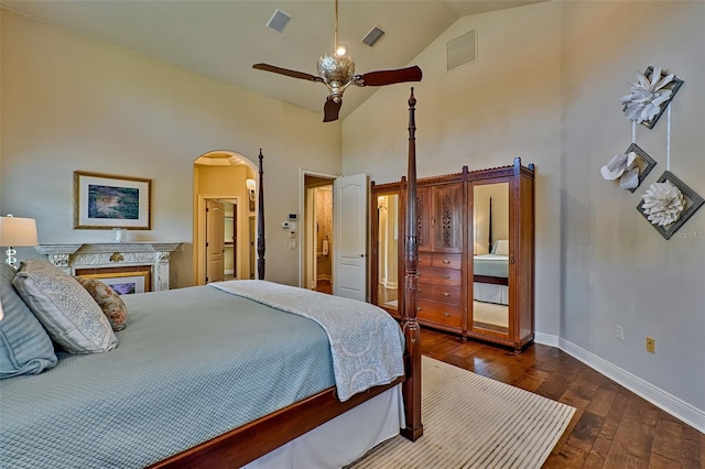 bedroom with ceiling fan, dark hardwood / wood-style floors, and high vaulted ceiling