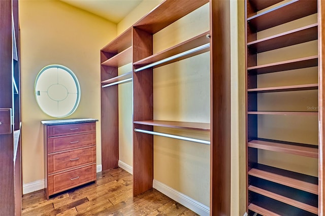 walk in closet featuring light hardwood / wood-style floors