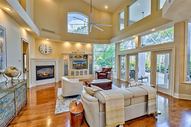 living room featuring hardwood / wood-style floors and ceiling fan