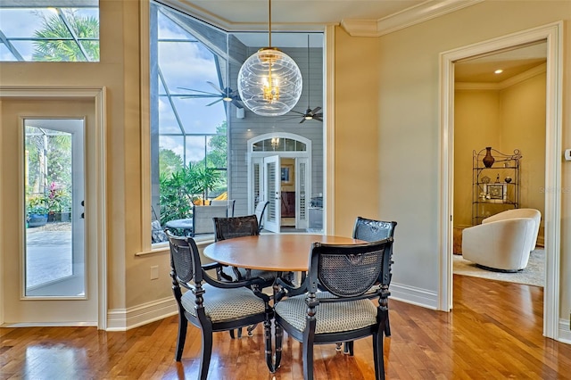 dining room featuring hardwood / wood-style flooring, ornamental molding, and ceiling fan