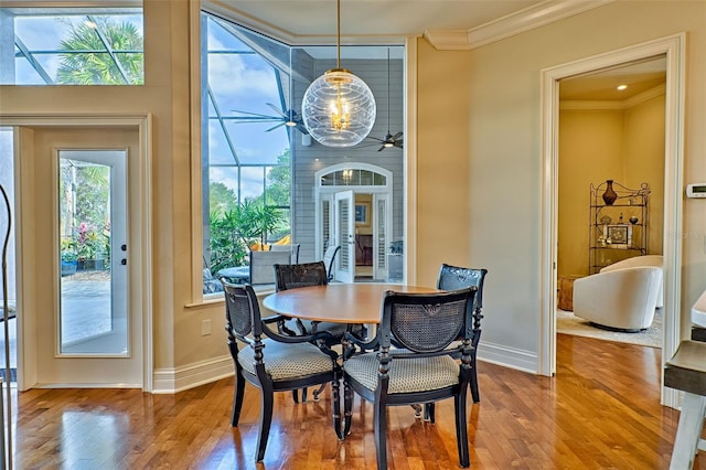 dining area with crown molding, ceiling fan, and hardwood / wood-style floors