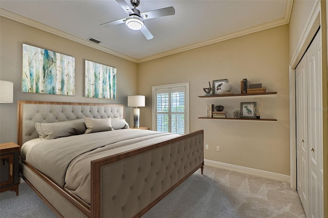 bedroom featuring light colored carpet, ornamental molding, and a closet