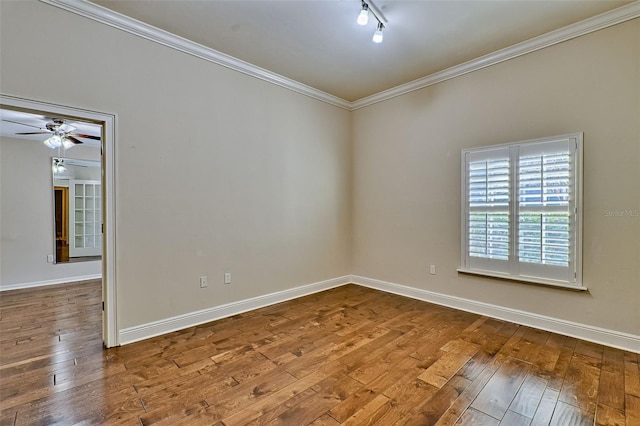 unfurnished room with crown molding, wood-type flooring, rail lighting, and ceiling fan