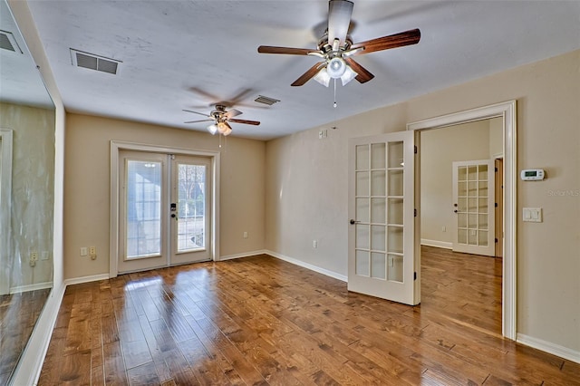 spare room featuring french doors, ceiling fan, and hardwood / wood-style floors