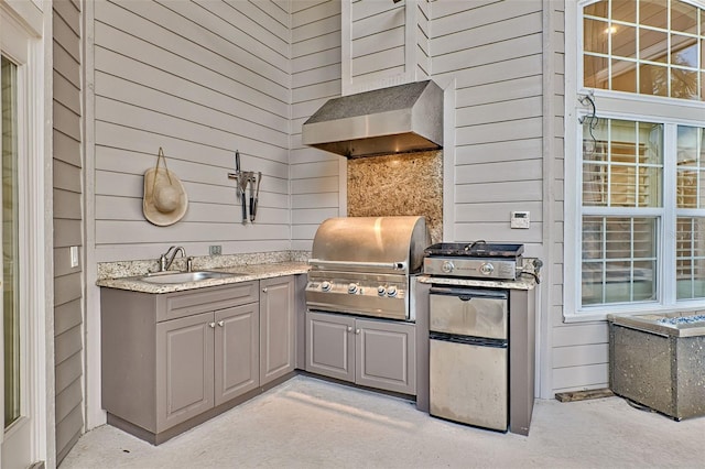 view of patio with a grill, sink, and exterior kitchen