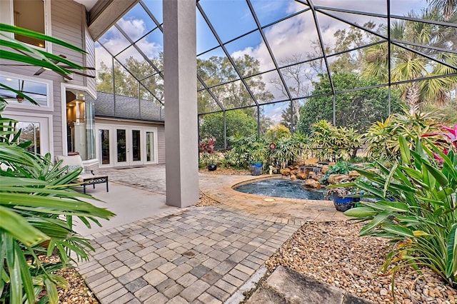 view of patio featuring a lanai