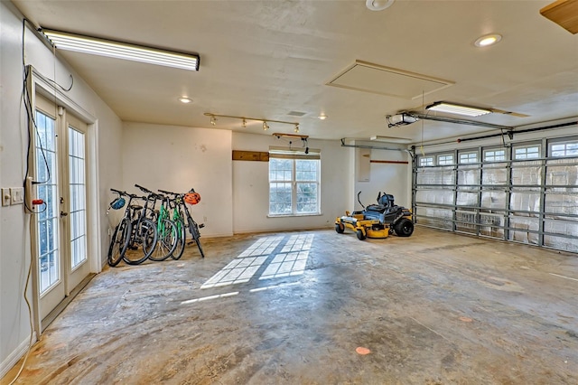 garage featuring a garage door opener and french doors