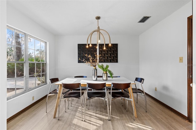 dining area featuring a chandelier and light wood-type flooring