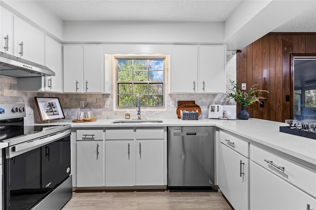 kitchen with sink, white cabinets, and appliances with stainless steel finishes