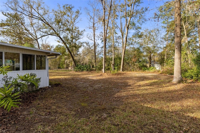 view of yard featuring a sunroom