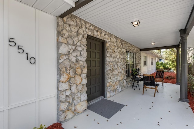 view of exterior entry featuring a porch