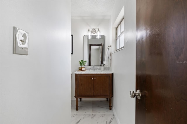 bathroom featuring vanity and a textured ceiling