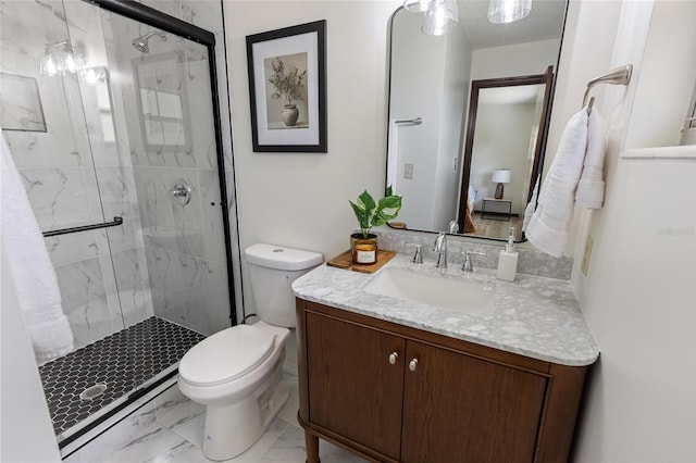 bathroom with a shower with door, vanity, and toilet