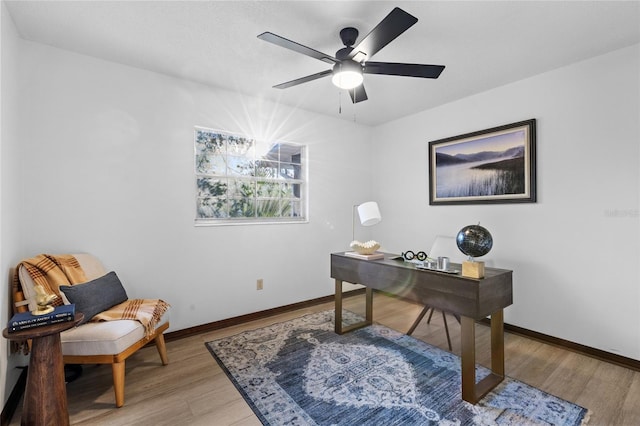 office space with ceiling fan and light hardwood / wood-style floors