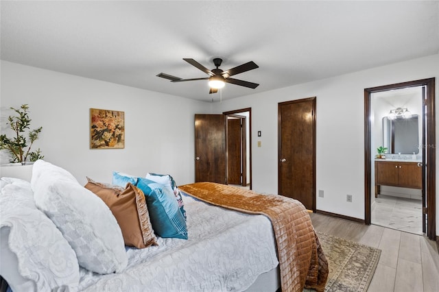 bedroom featuring ensuite bathroom, sink, ceiling fan, and light hardwood / wood-style flooring