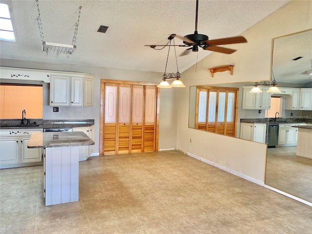 kitchen with lofted ceiling, sink, a kitchen island, decorative light fixtures, and stainless steel dishwasher