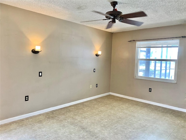 spare room featuring a textured ceiling and ceiling fan