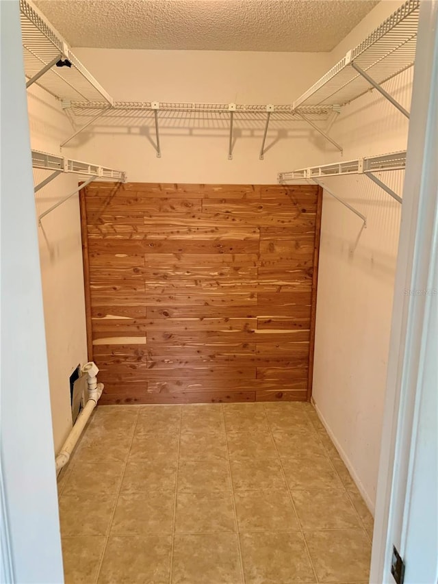 spacious closet featuring tile patterned flooring