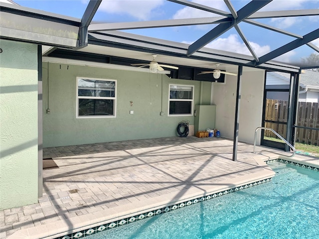 view of pool with a lanai, ceiling fan, and a patio area