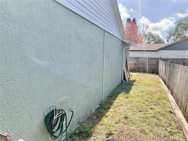 view of side of home featuring a lawn