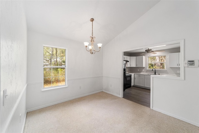 unfurnished dining area with lofted ceiling, sink, light colored carpet, and a chandelier