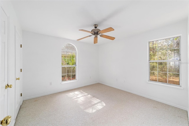 spare room featuring ceiling fan and carpet flooring