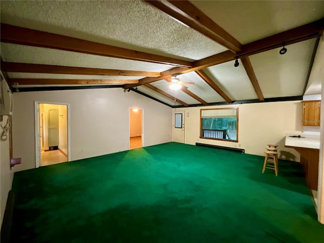 unfurnished living room featuring ceiling fan, vaulted ceiling with beams, and a textured ceiling