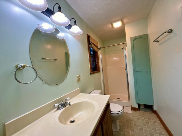 bathroom with toilet, vanity, a textured ceiling, and walk in shower