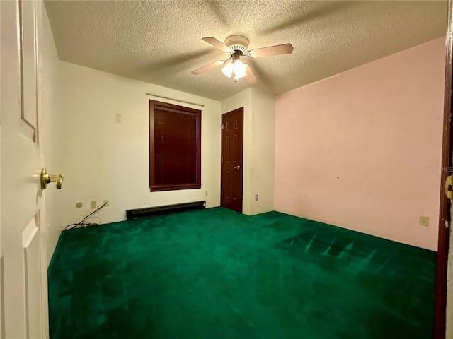 unfurnished bedroom featuring ceiling fan, carpet flooring, a textured ceiling, and baseboard heating