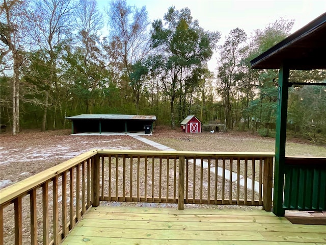 deck with a carport and a storage shed