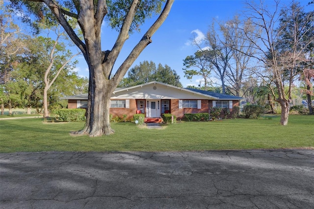 single story home with brick siding and a front lawn