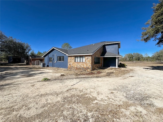 rear view of property featuring cooling unit