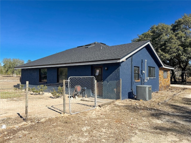 rear view of property with central air condition unit