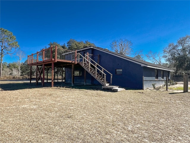 back of house featuring a deck