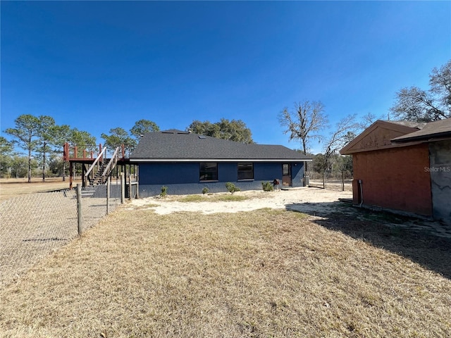 exterior space with a deck and a lawn