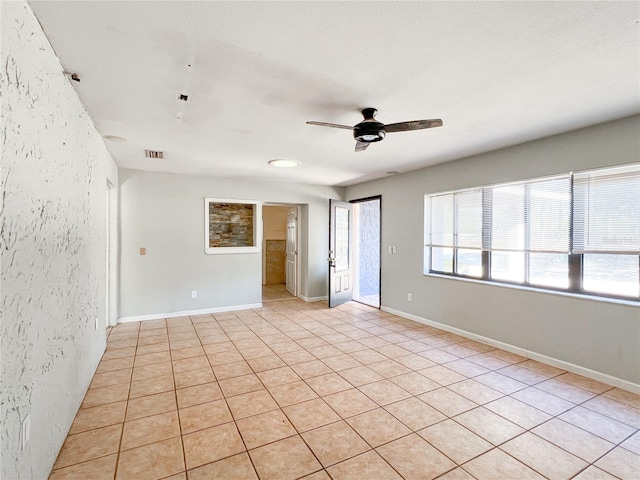 spare room with ceiling fan and a textured ceiling