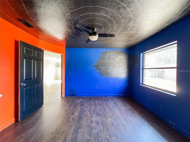 unfurnished room featuring hardwood / wood-style flooring, ceiling fan, and a textured ceiling