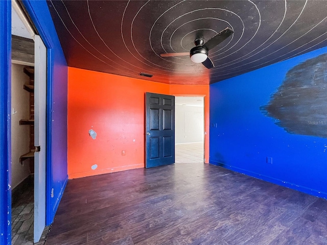 interior space with dark wood-type flooring and ceiling fan