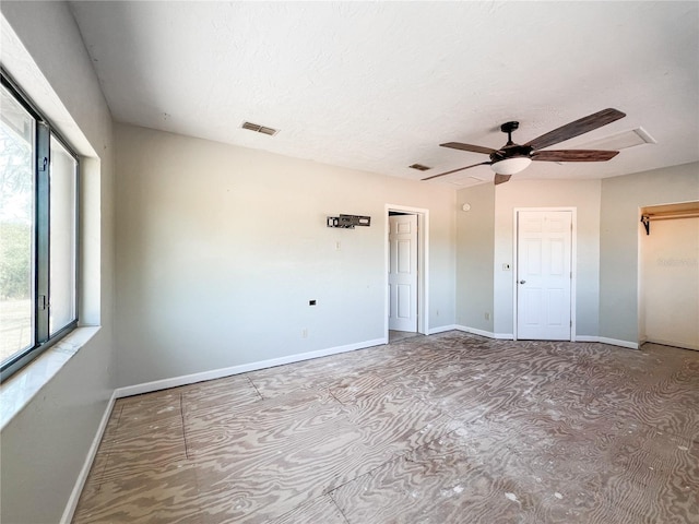 unfurnished bedroom featuring a textured ceiling and ceiling fan